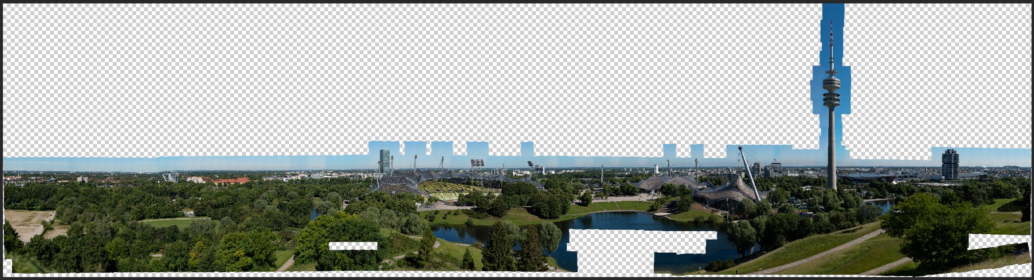 That very 600 mm Olympiapark panorama, caught mid-stitch. Every checkerboard square is a frame the stitcher could not place — almost the entire cloudless sky, which has no features to lock onto and has to be painted back in by hand. This is the 320,000 px monster that overran PSB.